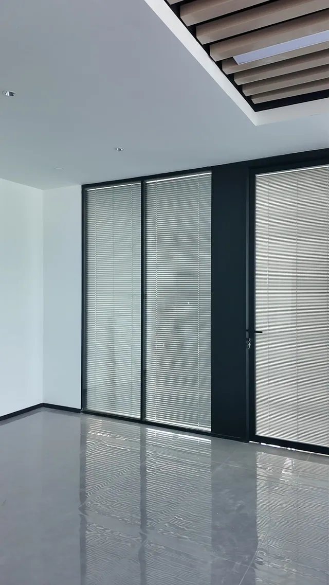 Completed double-glazed partitions with integrated blinds in an office entrance
